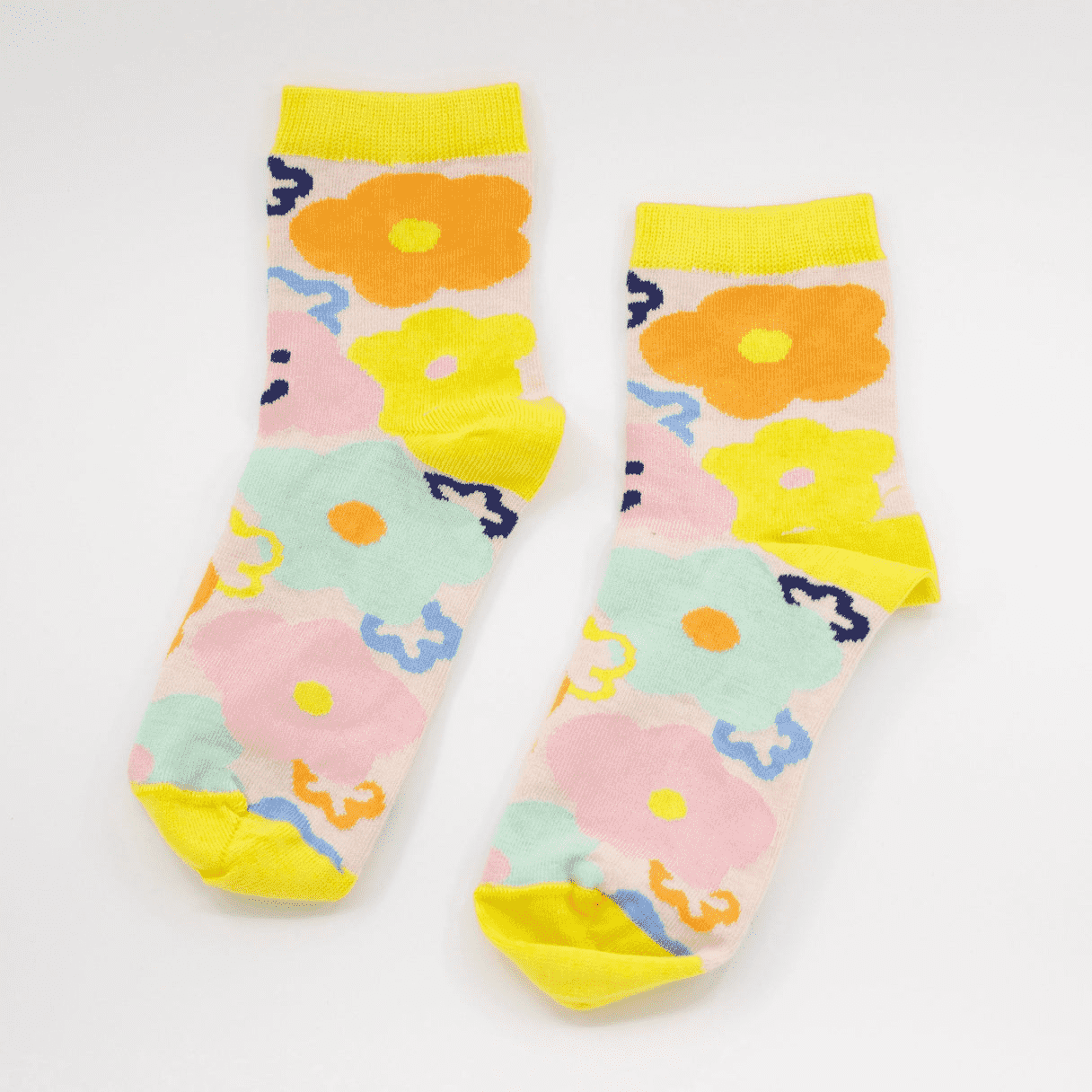 Bright socks with splashes of yellow, orange and blue flowers with little happy faces on either side, designed by Shuh Lee