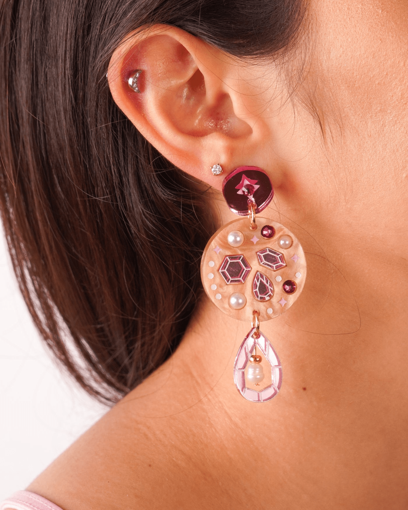 A close up of Flowature's Celestial Droplet earrings being worn. 