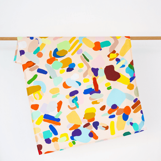 A super fun print by Shuh, It has a soft cream background with a mix of colourful abstract shapes. 