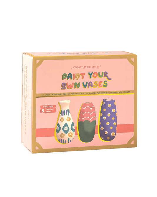 A super cute 'Paint your own vases" kit by Journey of Something. The kit comes in a pastel pink box with an illustration of three, colourful hand painted vases. 