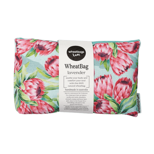 A beautiful Wheat Bag by Wheatbag Love features an aqua backdrop with Protea flowers. 