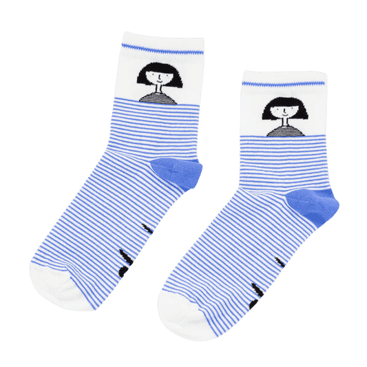 Shuh Lee Girl Striped Socks: Adorable white socks with a bold blue stripe extending from the toe to mid-calf. The heel features the word "shuh," while the ankle showcases a tiny black-and-white portrait of Shuh with her signature bob haircut and a sweet smile.