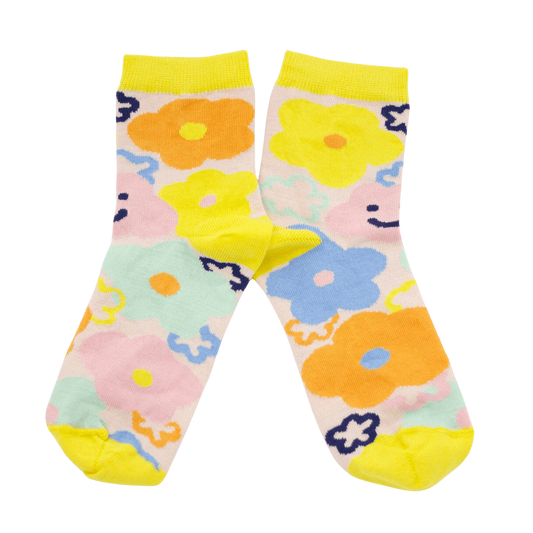 Bright socks with splashes of yellow, orange and blue flowers with little happy faces on either side, designed by Shuh Lee