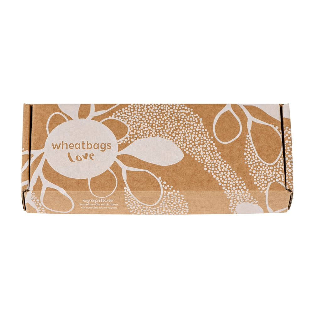 A small brown eye pillow box that reads "wheatbag Love" and features a silhouette of gum leaves.  